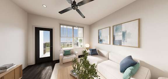 A living room with a white couch and a ceiling fan.