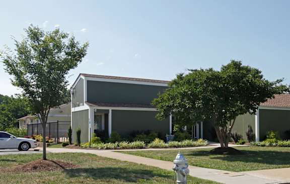 a gray building with a white fire hydrant in front of it