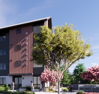 A modern building with a brown facade and a tree in front.