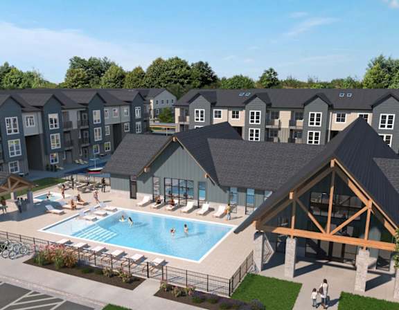 A large building with a pool in front of it.