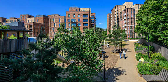 A view of a courtyard with people walking and sitting.