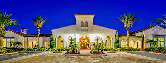 the master bedroom features a king sized bed and a flat screen tv at Hacienda Club Apartments in Jacksonville, FL