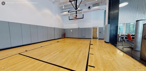 a basketball court in a gym with a basketball hoop