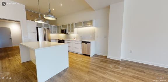 a kitchen with white walls and a wooden floor