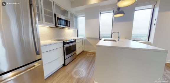 a kitchen with white cabinetry and stainless steel appliances