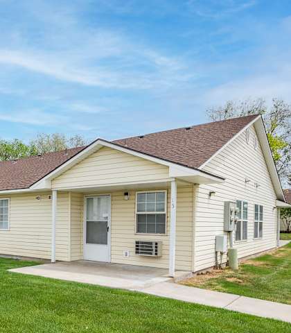 a white house with a yard and a sidewalk