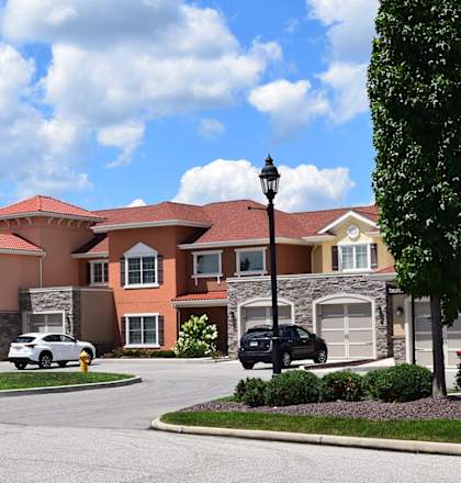 a large house with a street in front of it at The Residences at Toscana Park, Granger, Indiana