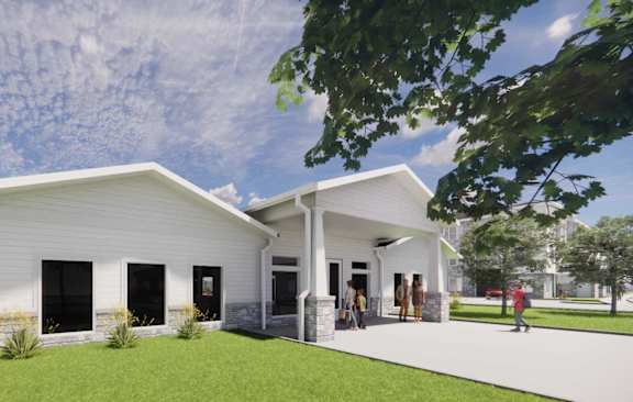 A modern white house with a black door and windows is surrounded by greenery. at Callaway at Holland Pointe Apartments, Iowa