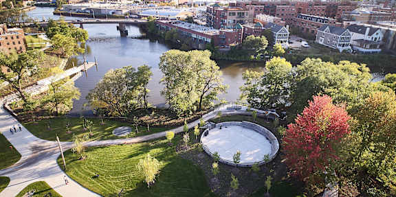 an aerial view of a park and a body of water