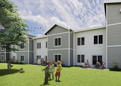 A family is playing outside of a Simonson home. at Callaway at Holland Pointe Apartments, Iowa