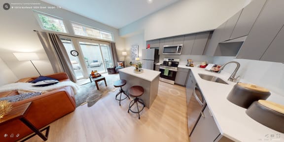 a view of a kitchen and living room with a couch and