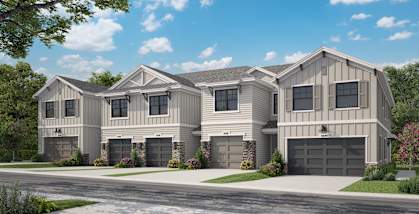 A row of houses with garages and driveways.