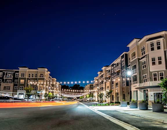 a city street at night with buildings and street lights