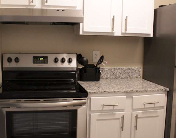 Kitchen with granite countertops and stainless steel appliances at Stillwater at Grandview Cove