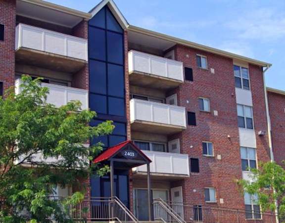 an apartment building with a red brick facade