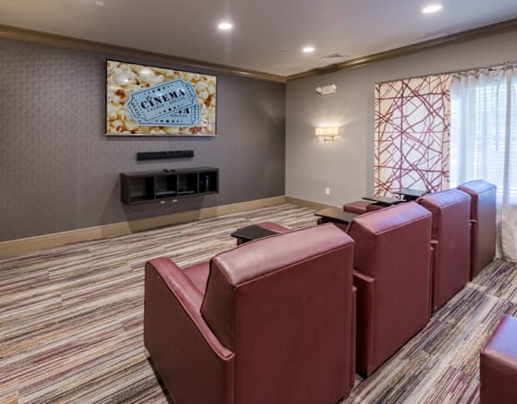 A room with red chairs and a painting on the wall at Axis at Lakeshore Apartments, Massachusetts