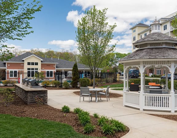 A gazebo is surrounded by a circular garden in the middle of a park at Axis at Lakeshore Apartments, Massachusetts, 02324
