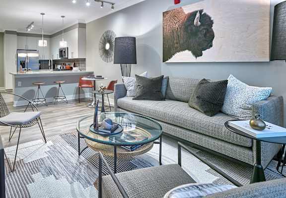 A modern living room with a grey couch and a glass coffee table. at Madison Ellis Preserve, Pennsylvania