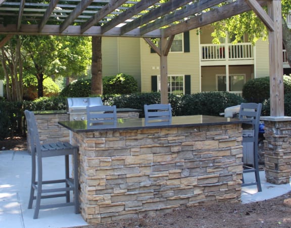 Grilling and dining area under a large pergola at Stillwater at Grandview Cove
