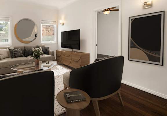 A modern living room with a black chair and a grey sofa.