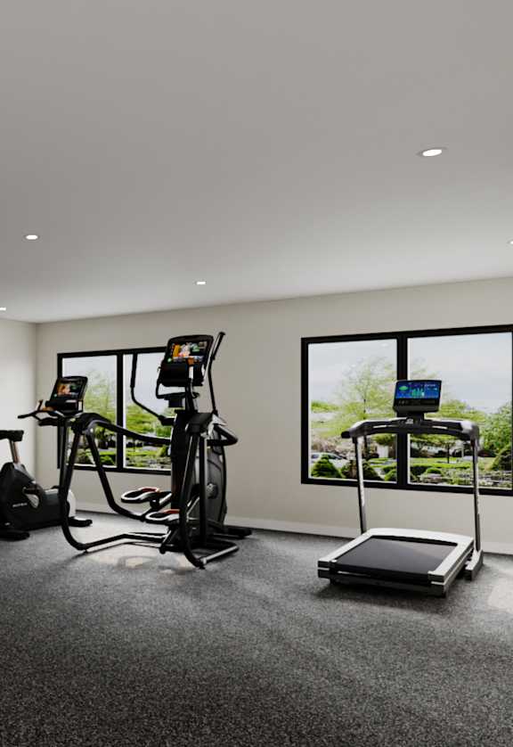 A gym with a variety of equipment including a treadmill, weights, and a bench press.