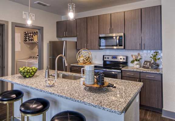 the heights at harper's preserve apartments kitchen with granite countertops and stainless steel appliances
