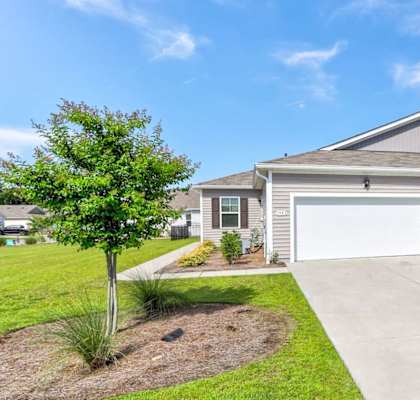 a house with a driveway and a garage door in front of it