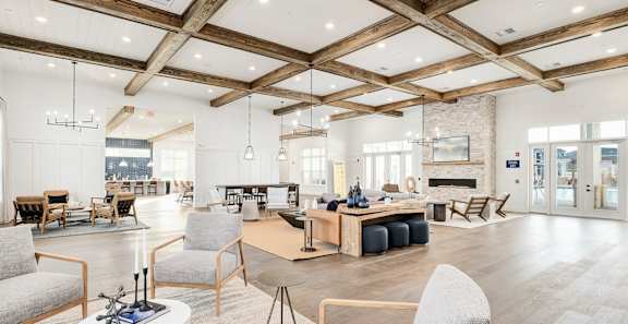 A spacious living room with a fireplace and a dining table set up.
