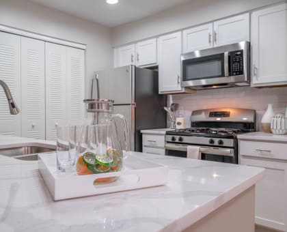kitchen with stainless appliances and white cabinetry at The Residence at Christopher Wren apartments