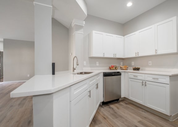 Kensington Grove apartments large white kitchen with white cabinets and a stainless steel dishwasher