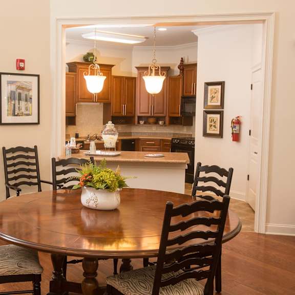 A dining room with a table and chairs.