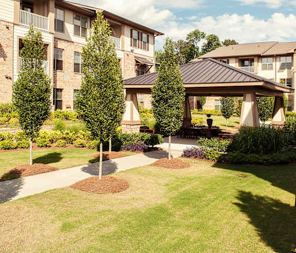A large grassy area in front of apartment buildings.