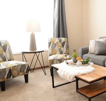 a living room with a couch and two chairs