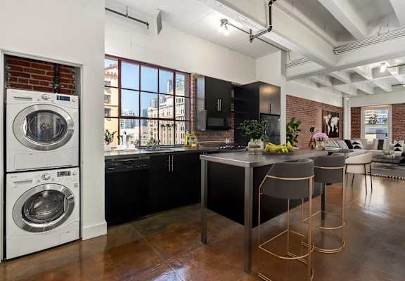 A modern kitchen with a large island and bar stools.