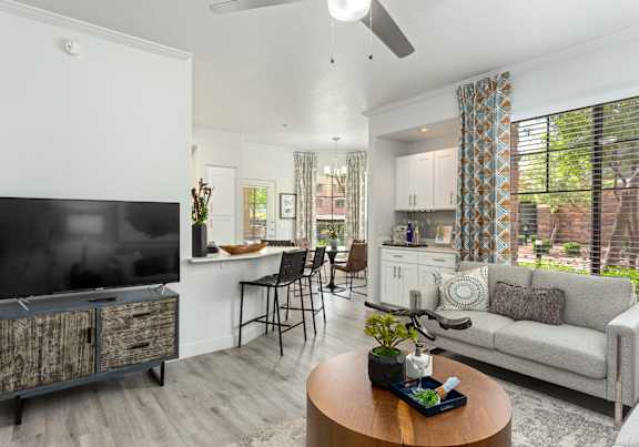 A living room with a television, a couch, and a coffee table.