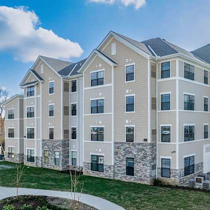 A row of modern apartment buildings with a clear blue sky above.