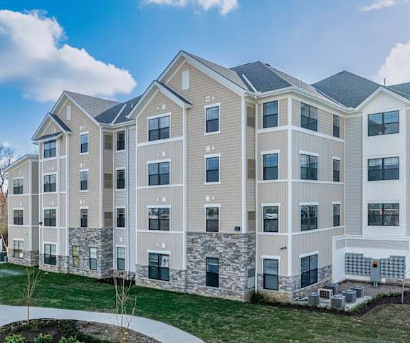 A row of modern apartment buildings with a clear blue sky above.