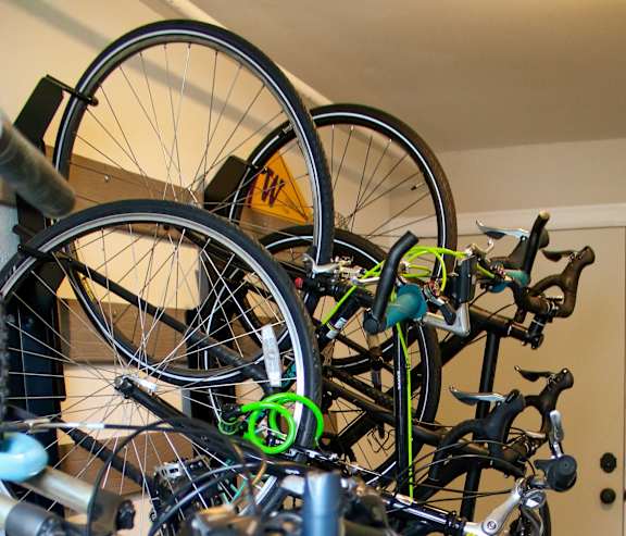 a rack of bikes in a room with a door