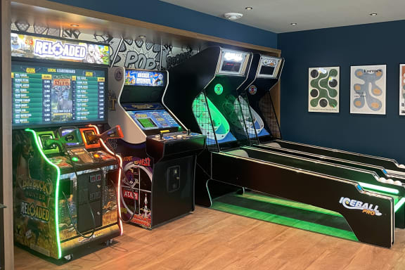 A row of arcade games including a reel machine and a ball machine at The Bosk Apartment Homes, Minnesota