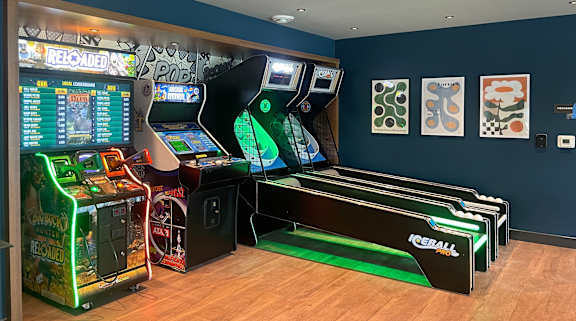 A row of arcade games including a reel machine and a ball machine at The Bosk Apartment Homes, Woodbury