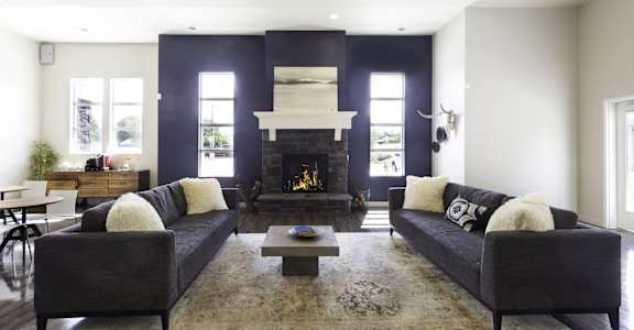 a living room with a fireplace and two couches