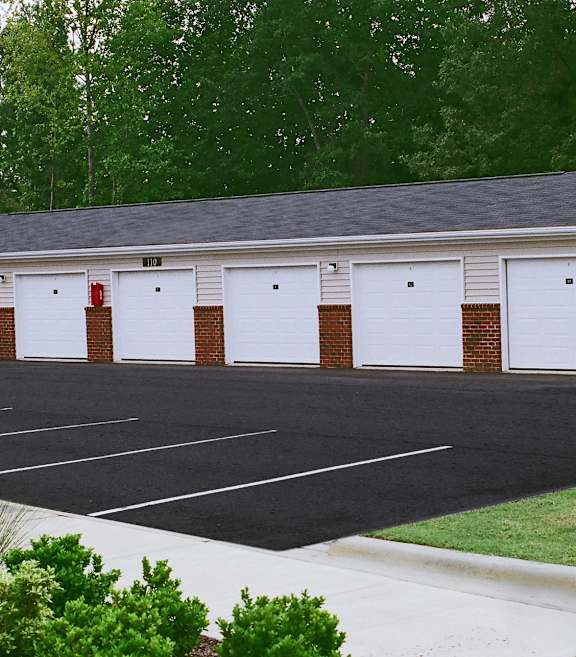 A building with a parking lot in front of it.