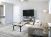 Thumbnail 2 of 5 - a living room with a couch and a coffee table and a television