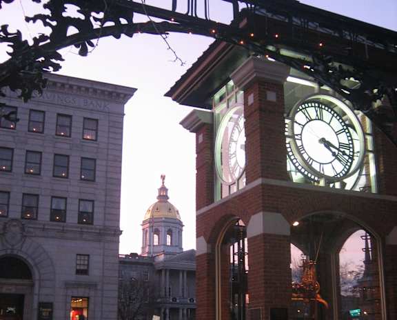 A clock tower stands in front of a building with a sign that says Kings Bank.