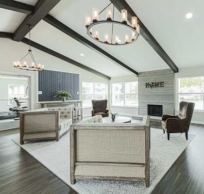 a living room with a fireplace and a chandelier