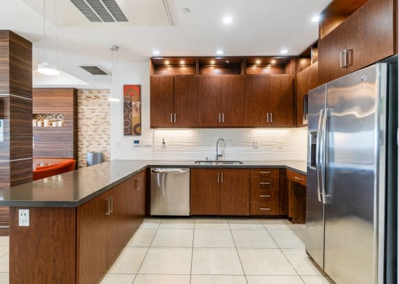 a modern kitchen with wooden cabinets at The Adler Apartments, Los Angeles, CA, 90025