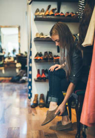 woman trying on shoes while shopping downtown baltimore apartments the zenithat The Zenith, Maryland, 21201