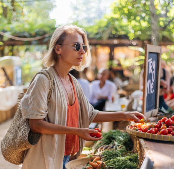 a woman shopping at a farmers market
