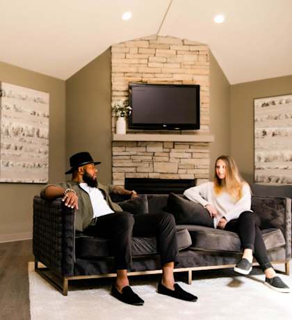 a man and woman sitting on a couch in a living room at Rosemont Place Apartments, Des Moines, IA, 50320