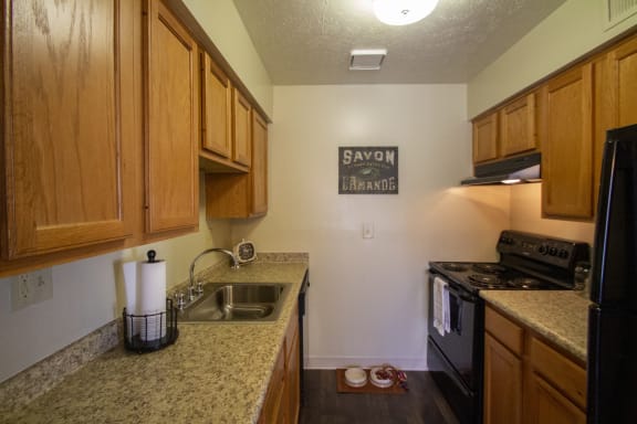 This is a photo of the light honey oak cabinets in the kitchen of a 1 bedroom apartment at Deer Hill Apartments in Cincinnati, OH.